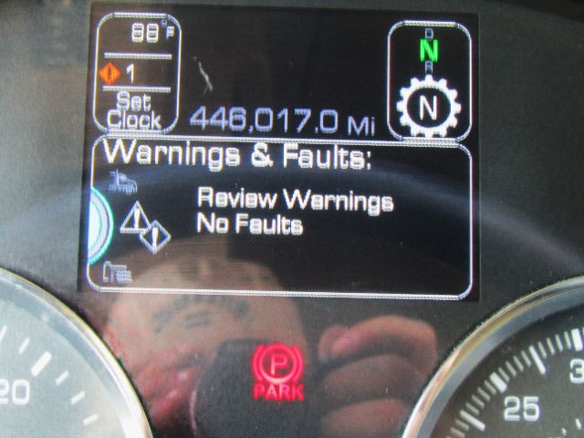 Dashboard display showing 446,017.0 Mi, Warnings & Faults: Review Warnings No Faults, gear indicator N, park brake symbol, circular gauge faces.