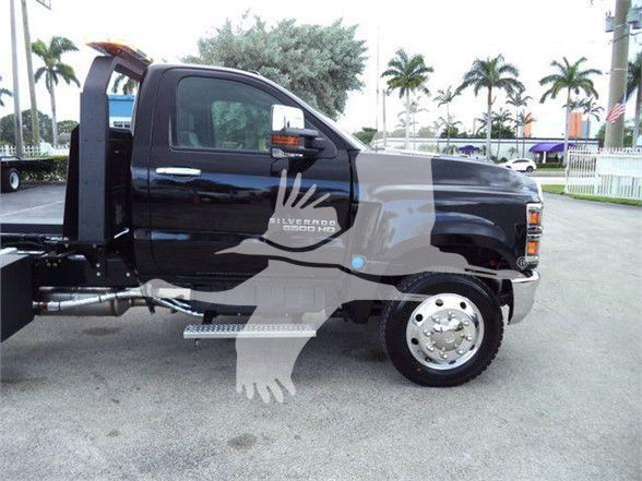 Tow truck cab side view showing Chevrolet Silverado 6500HD branding and side step, with logo watermark across the image.