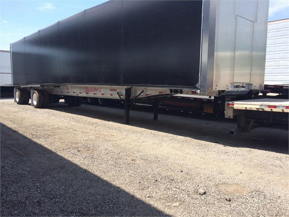 2024 Fontaine load covering solutions tarp system trailer showing curtain side with black tarp and undercarriage