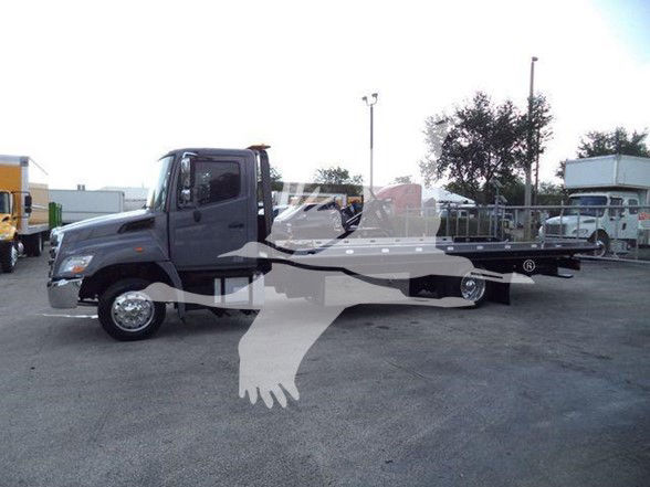 2014 Hino 258ALP tow truck side profile showing flatbed body and dual rear wheels.