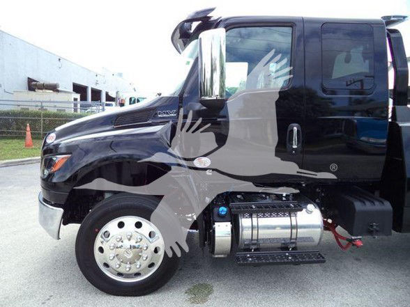 Truck cab area of a 2025 International MV showing side view with chrome fuel tanks and steps.