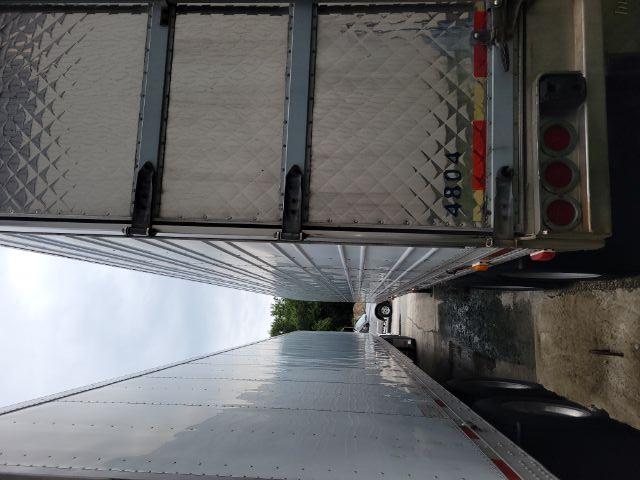 Trailer rear and side view of a 2000R utility trailer with diamond plate rear doors and dual tires.