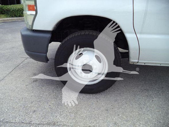 Ford E-450 front wheel well and wheel visible with partial front bumper; no legible labels or stickers.