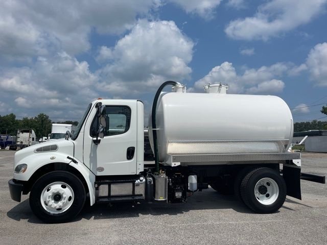 2015 Freightliner M2 sewer rodder septic truck side view showing white cab and large cylindrical tank with hoses and toolbox.