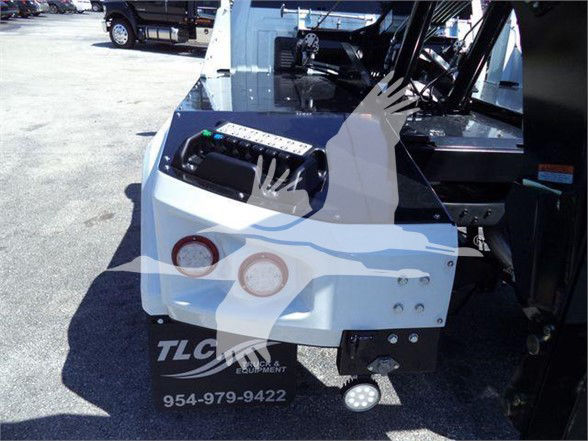 Ram 5500 Tow truck rear view showing hydraulic control panel, bumper with two circular lights, license area, and rear hitch.