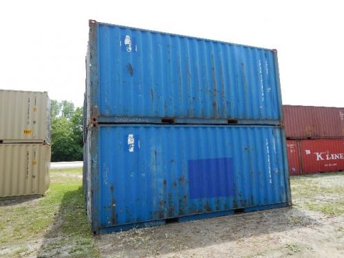 Two stacked blue 20' wind weather tight containers on gravel lot.