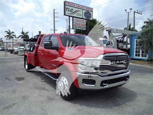 Ram 5500 pickup truck front and side view in red color with chrome grille and black wheel wells.