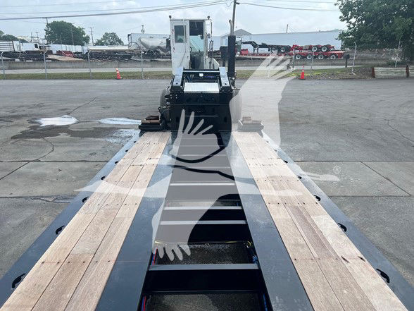 XL Specialized XL110Hdgs18 lowboy trailer deck with wooden planks and gooseneck hitch area visible.