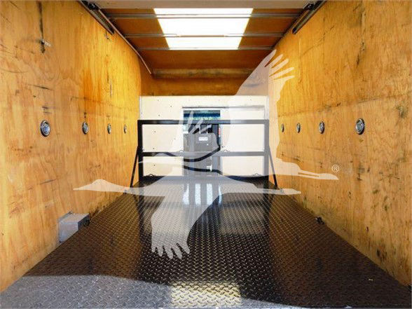 2015 Ford E350 SD cargo box interior showing wooden walls, diamond plate floor, and rear entry ramp.