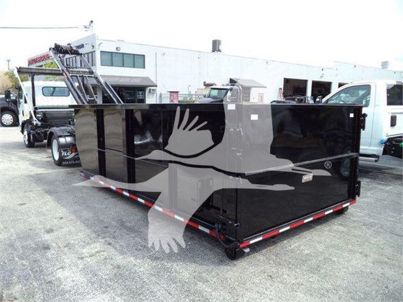 Isuzu NRR truck with a large black dump body in a lot. No legible labels visible on the body in this image.