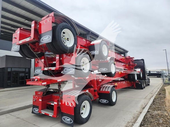Large red multi-axle trailer/carrier with stacked trailers and white wheels, showing multiple axles and tires.
