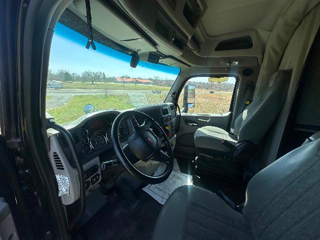 Truck cab interior of a 2019 Peterbilt 579 showing steering wheel dashboard and driver seat.