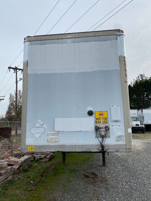 Rear view of a two-axle trailer with a light gray Duraplate panel, vertical rivets, and a yellow 'Not for Rail Use' sticker near the electrical box.