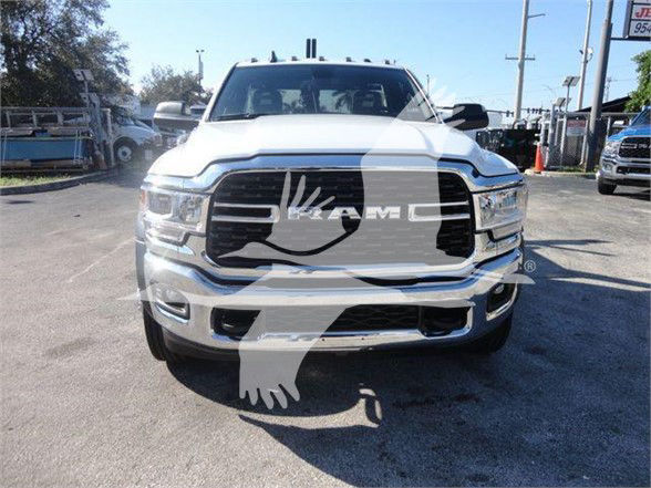 Front view of a white 2024 Ram 4500 SLT pickup truck in a dealership lot showing the front grille, headlights, and bumper with a watermark across the image.