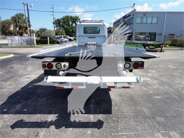Rear view of a 2022 Hino 268A tow truck flatbed with branding and rear lights.
