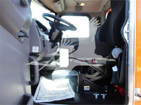 Peterbilt truck interior cabin view showing driver seat, steering wheel, dashboard, and entry area.