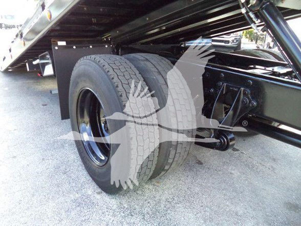 Truck rear dual tires and suspension undercarriage of 2019 International DURASTAR 4300 showing dual axle with leaf springs and frame.