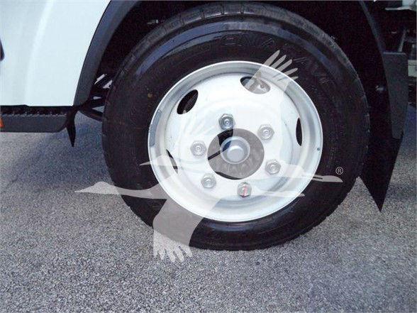 Isuzu NPR HD front wheel showing steel wheel with lug nuts and tire.