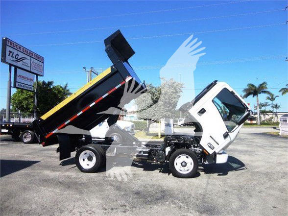 Isuzu NPR HD dump truck in service with dump bed raised, white cab, black and yellow bed, visible chassis and wheels.