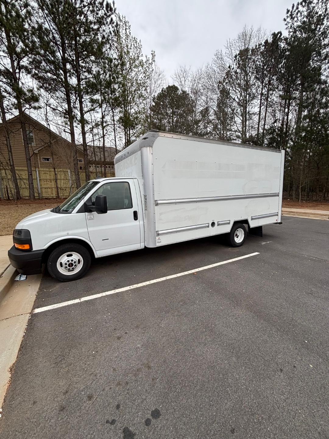 Box truck cargo area with GMC Savana 3500 cab white, side trailer blank, single rear wheel, parked in a lot.