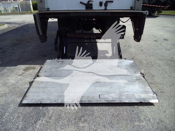 Truck reefer chassis with a lowered metal liftgate platform showing nothing but platform surface and support frame.
