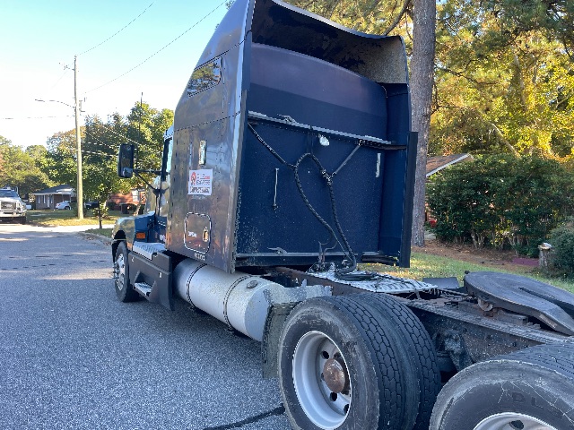 2007 Kenworth T600 conventional sleeper truck viewed from rear-left side showing cab and rear axle with fuel tank.