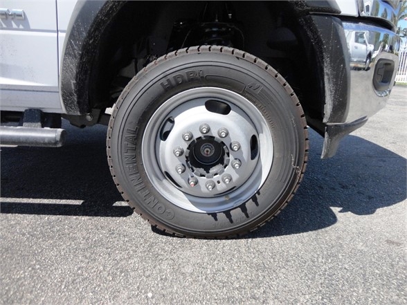 Ram 5500 HD wheel and tire assembly showing Continental HD R4 tire and silver steel wheel, front wheel well visible