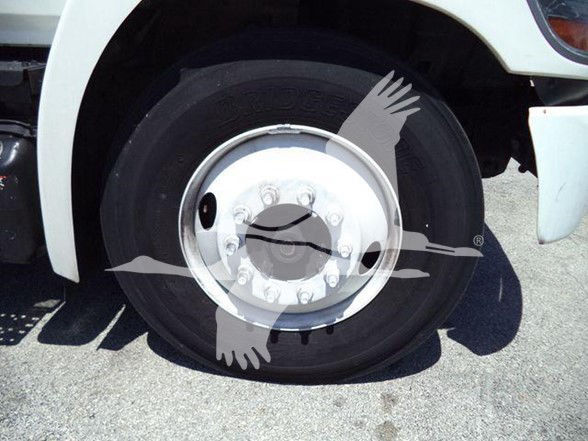 Truck wheel showing front 10-bolt hub with lug nuts and tire sidewall.