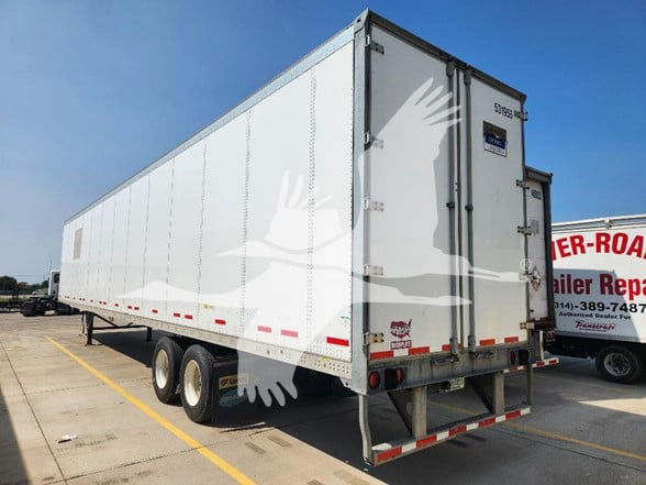 1999 Wabash trailer rear view with printed window brand stickers and dual rear doors.