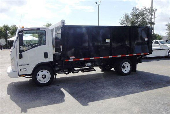 Isuzu NPR HD dump truck side view showing white cab and black dump body.