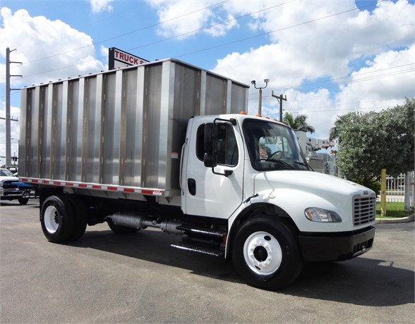 2014 Freightliner BUSINESS CLASS M2 106 dump truck in serviceable condition with aluminum dump body and white cab, front-to-side view.