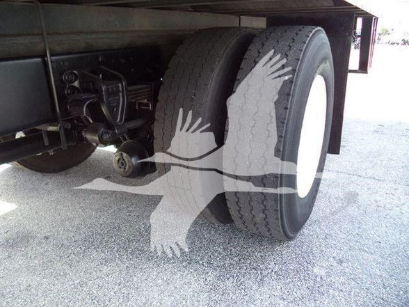 Rear view showing dual rear wheels on a reefer truck with visible suspension components.