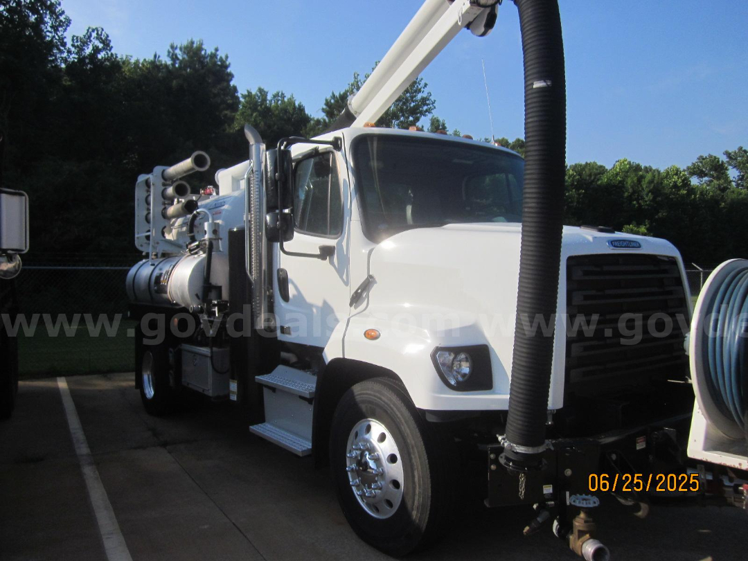 Front-left view of a white 2017 Freightliner Vactor vacuum truck with large hose reel and hydraulic boom.