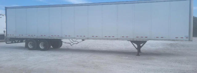Utility trailer with a long rectangular box on dual-axle wheels and a front support leg extended; side panels have small rectangular access doors.