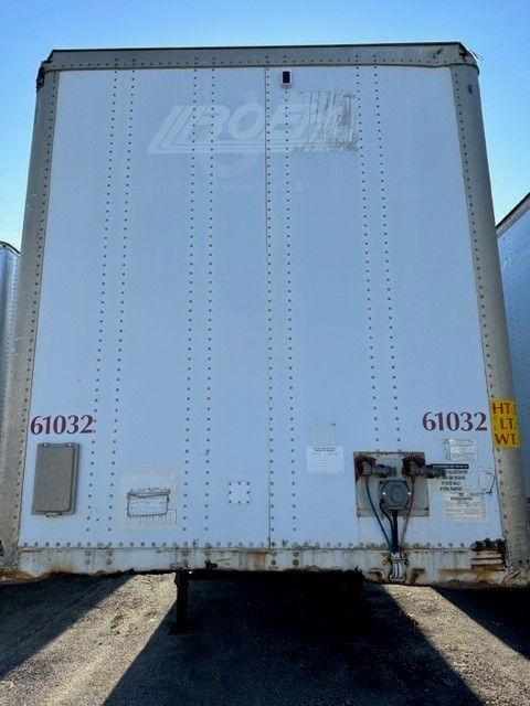  trailer rear showing Wabash Duraplate storage trailer with riveted aluminum exterior doors and rear underride guards, visible hazard stickers and serial numbers 61032