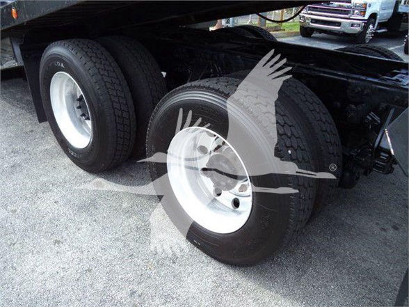 Rear dual-axle truck tires with white rims, undercarriage view of a 2014 Peterbilt 367 trailer configuration.