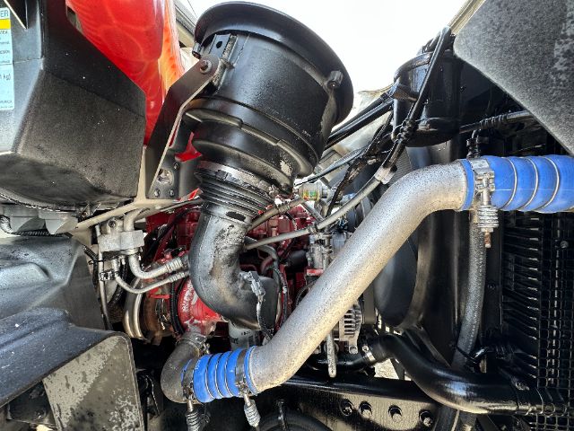 Freightliner 108SD engine bay showing intake duct, intercooler piping, hoses with blue silicone couplers, and engine components.