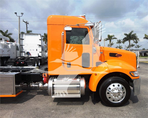 Orange Peterbilt 337 truck cab and chassis side view showing fuel tank and step.