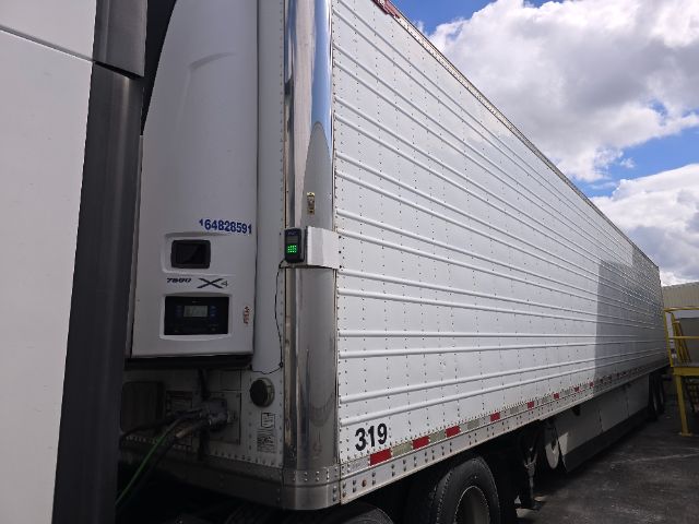 Great Dane trailer for reefer with aluminum side, numbers 164828591 and 319, vertical corner post with locking mechanism, landing gear, undercarriage visible.