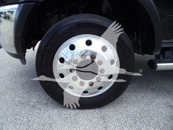 Truck wheel with polished chrome hubcap and black tire; watermark across wheel obscures some details.