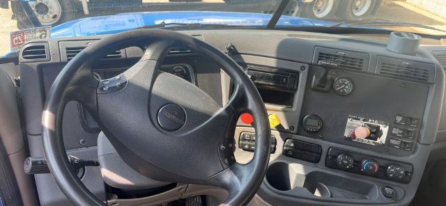 Dashboard and steering wheel of a 2016 Freightliner Cascadia Daycab showing instrument cluster, control panels, and steering wheel with Freightliner emblem.