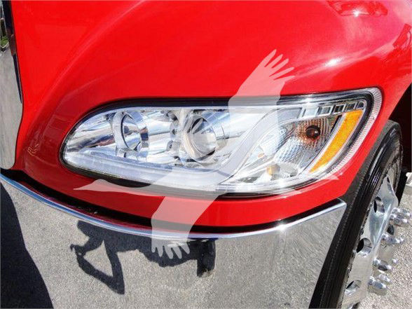 Peterbilt 337 truck front headlight area in red paint with chrome bumper and wheel, showing badge text not visible.