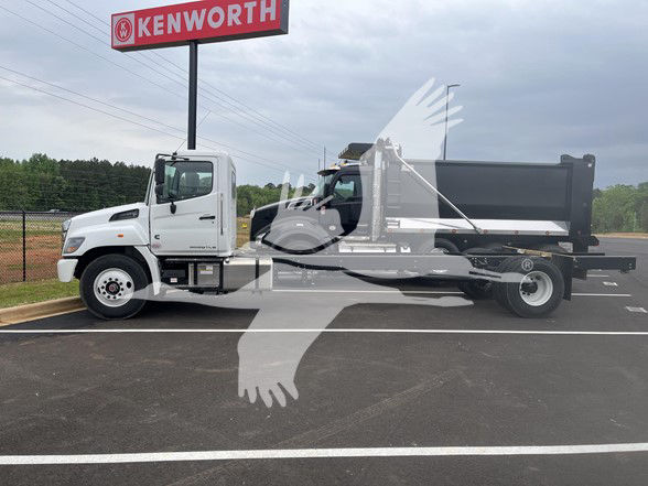 2026 Hino L6 cab and chassis truck with white cab and black dump bed, parked at Kenworth dealership lot.