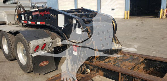  Fontaine 55 Ton lowboy trailer with drop side rails showing hydraulic gooseneck and rusted deck edge.