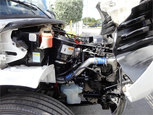 Engine bay of a 2014 Freightliner Business Class M2 106 showing components and hoses in the front left area.