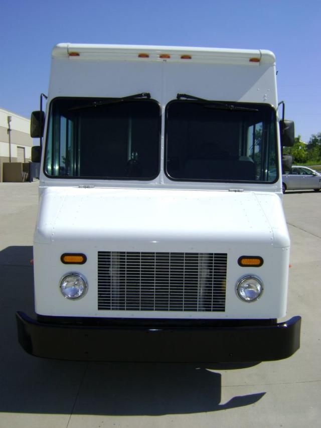 Front view of a white 2007 Freightliner MT45 step van with large grille, round headlights, orange marker lights, and a black bumper.