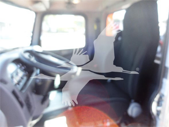Interior of a 2022 Peterbilt 337 cab showing driver's seat and steering wheel with a large watermark overlay of a bird logo.