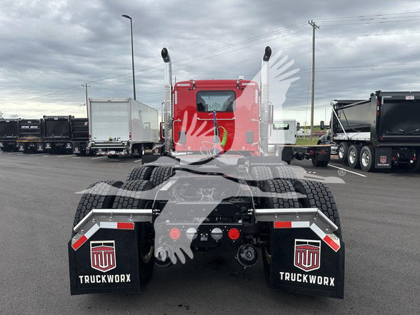 Kenworth T880 tractor rear view showing fifth-wheel coupling, dual rear axles, and mudflaps with TruckWorx branding.