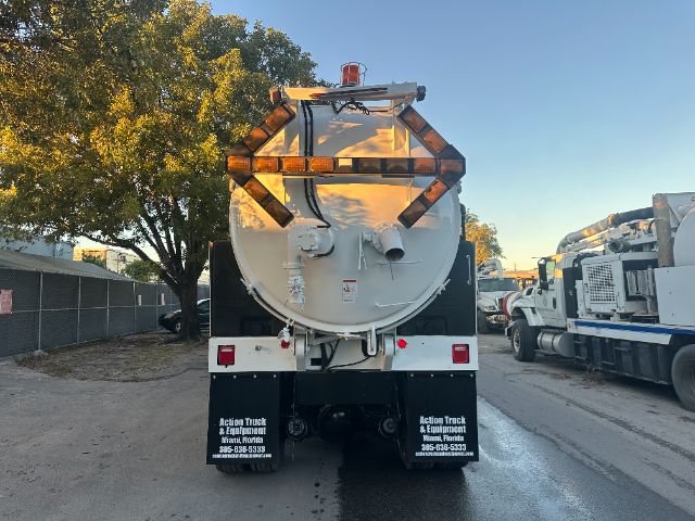 Rear view of a 2006 Sterling L8500 vacuum truck showing circular tank, rear doors, and bumper with warning lights.
