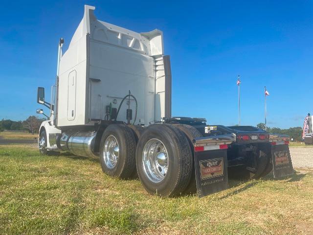 Peterbilt 579 truck rear view showing dual rear axles and chrome fuel tanks
